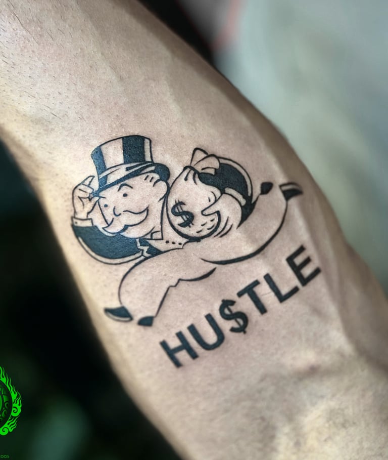 a tattoo on forearm with monopoly character holding a bag of money and "hustle" lettering.