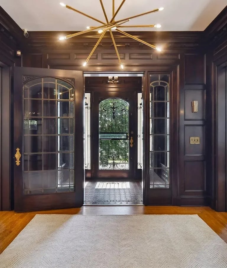 a large foyer with a chandelier and a chandelier