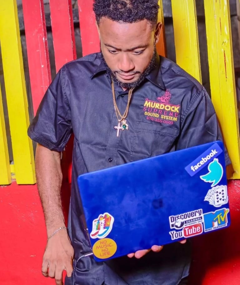 a man in a black shirt and a laptop