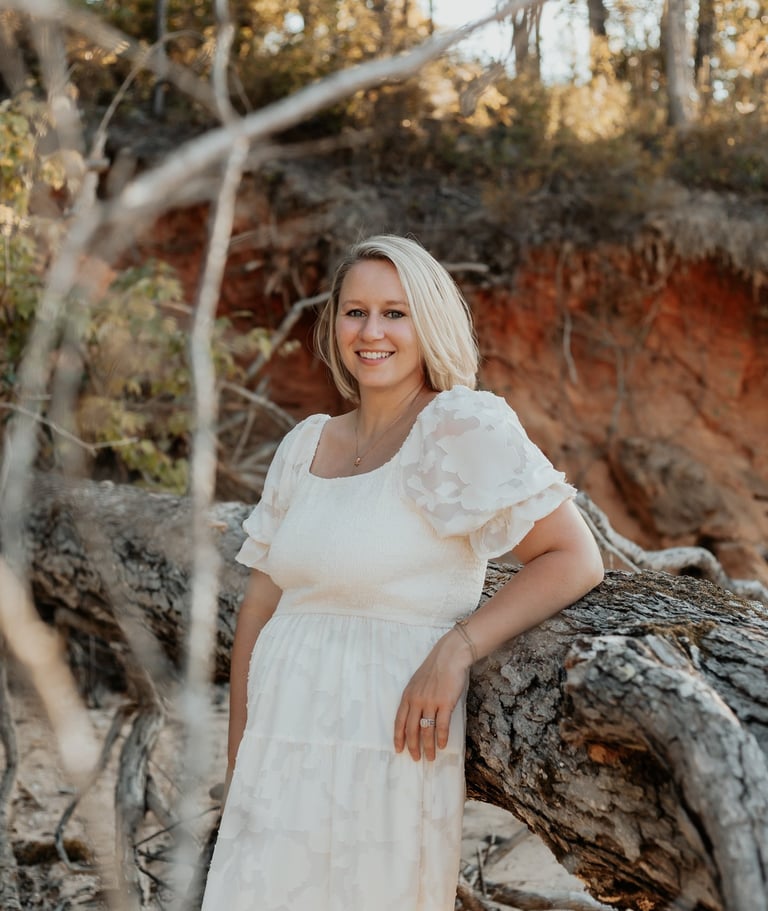 Picture of Emily by a fallen tree