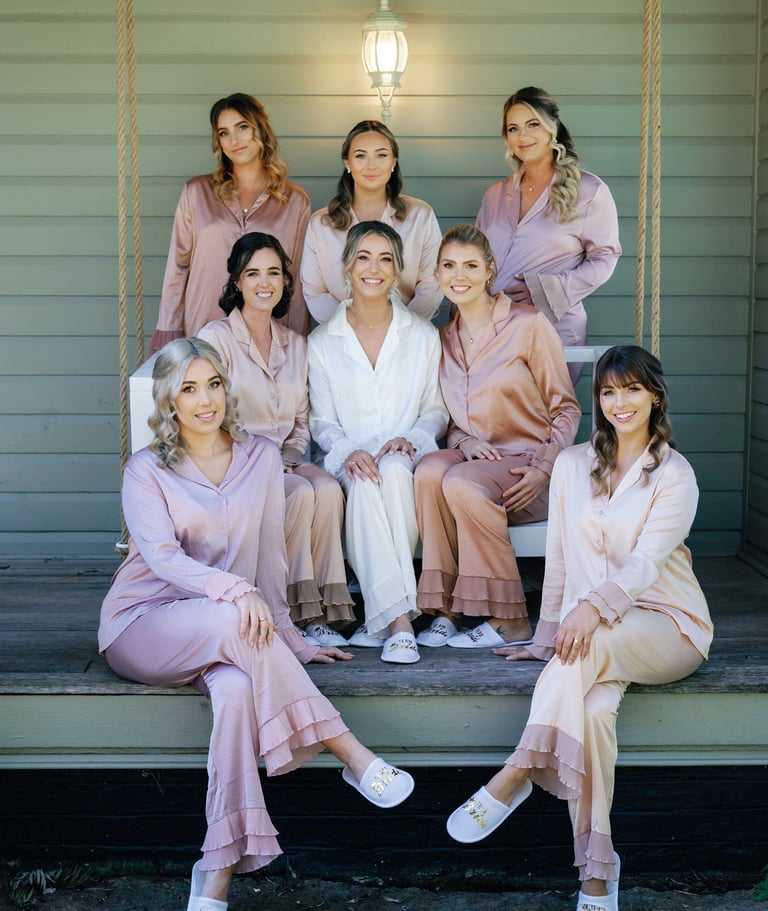 a group of women in pink robes posing for a photo