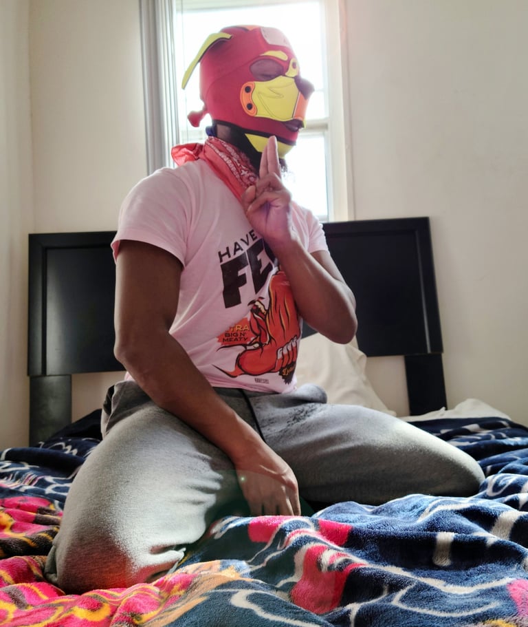 Man posing in his room wearing a pup hood.