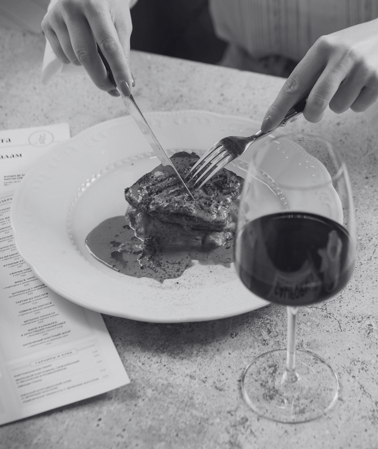 a photo of a woman eating dinner at a piano piano reservation