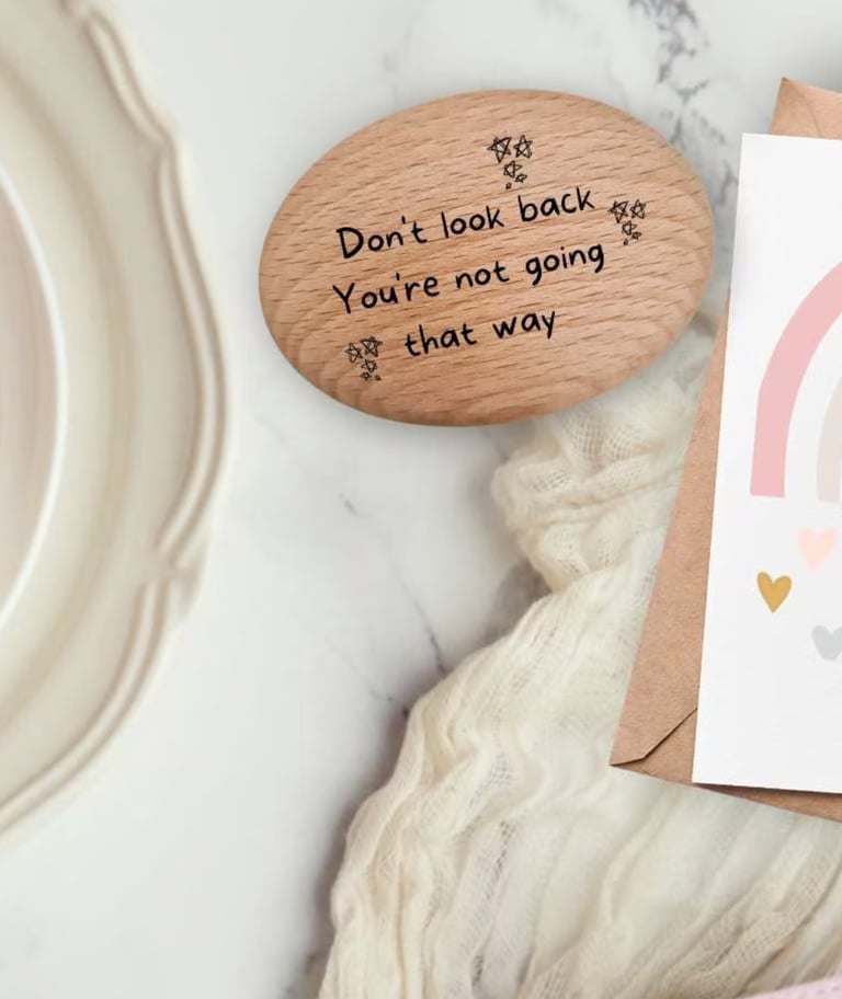 a card with a rainbow and a positivity pebble