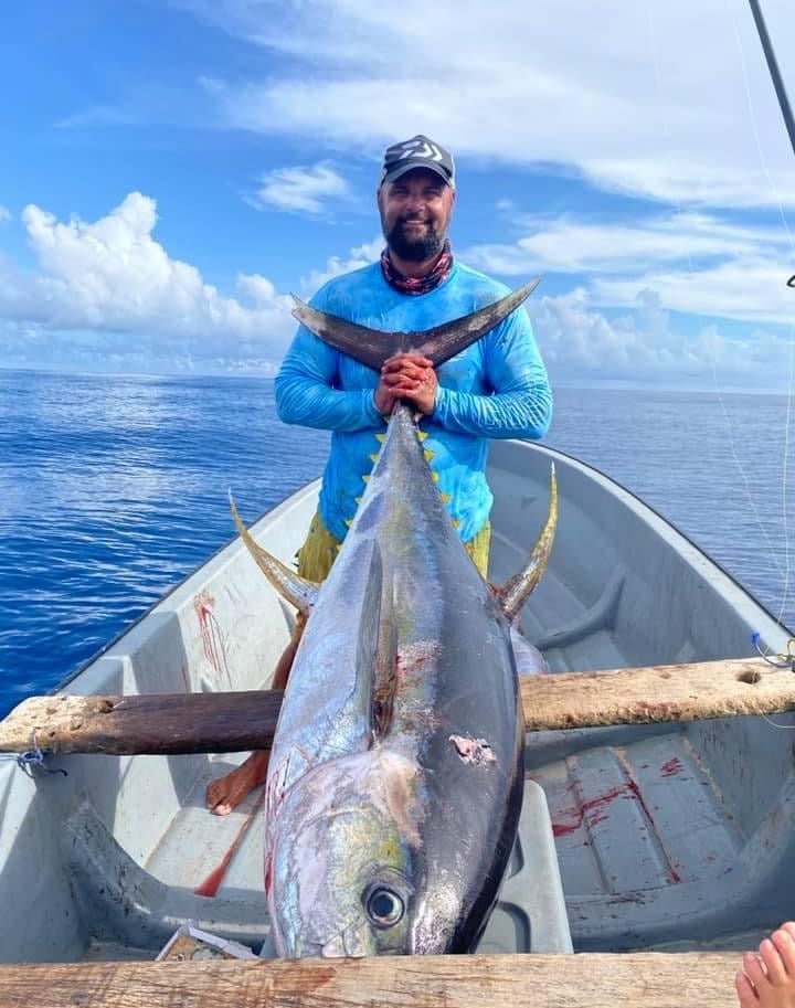 Zanzibar Fishing Trips – angler holding a massive Yellowfin Tuna on a fishing boat
