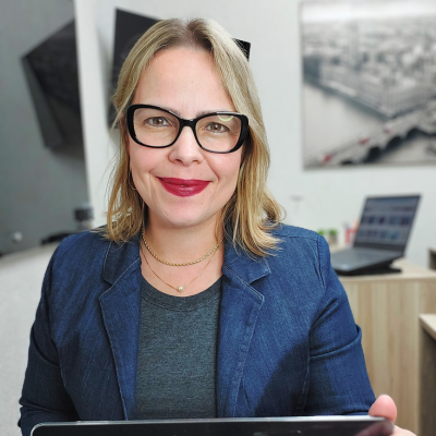 a woman in glasses and a blue blazer jacket