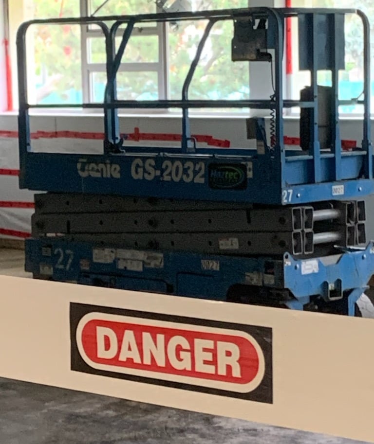 Scissor lift with a Danger Banner Guard across it