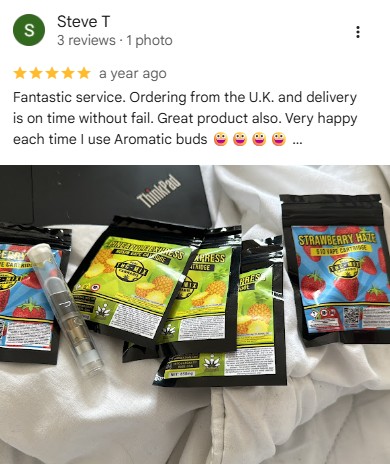Customer review photo showing Strawberry Haze and Pineapple Express vape cartridges from Aromatic Buds.