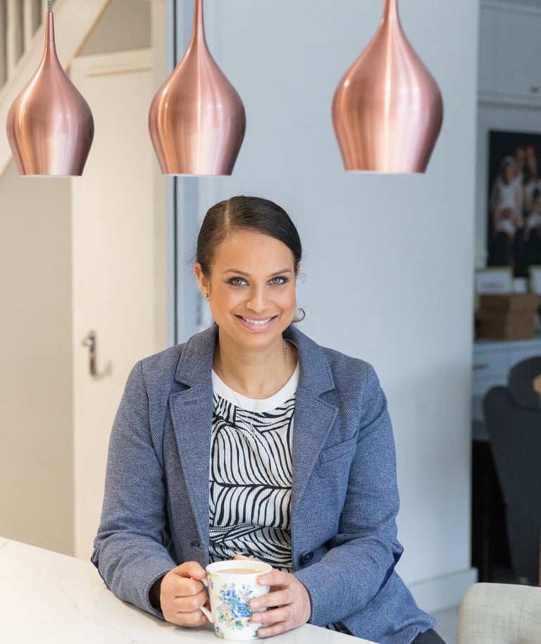 branding image of a woman sitting at a table with a cup of coffee