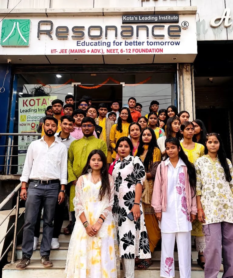 Students and teachers posing at Resonance Kota coaching institute for IIT-JEE and NEET preparation.