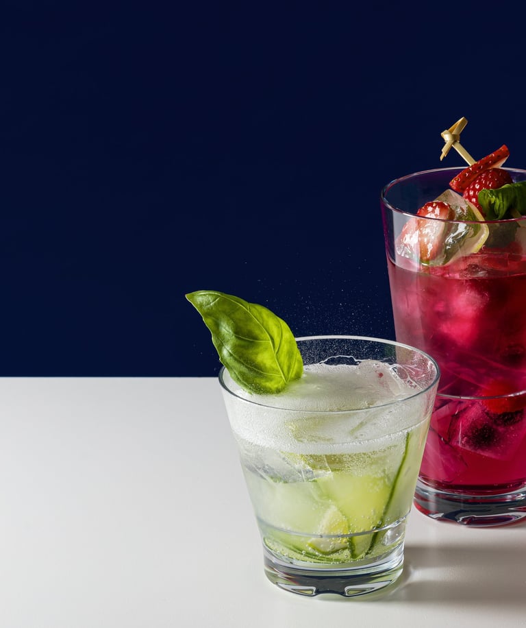 Product photography - two glasses of fruit juice with strawberries and cucumber