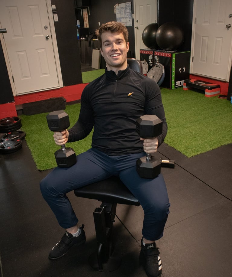 dustin king holding weights in his gym