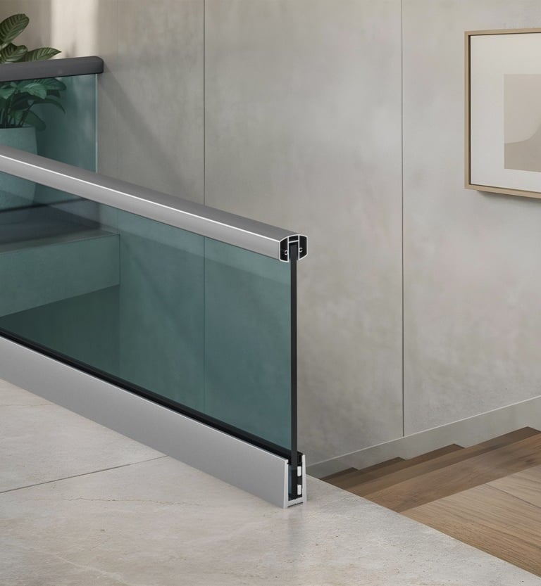 Fly Metals Modern glass railing with aluminum handrail and base shoe for interior staircase.