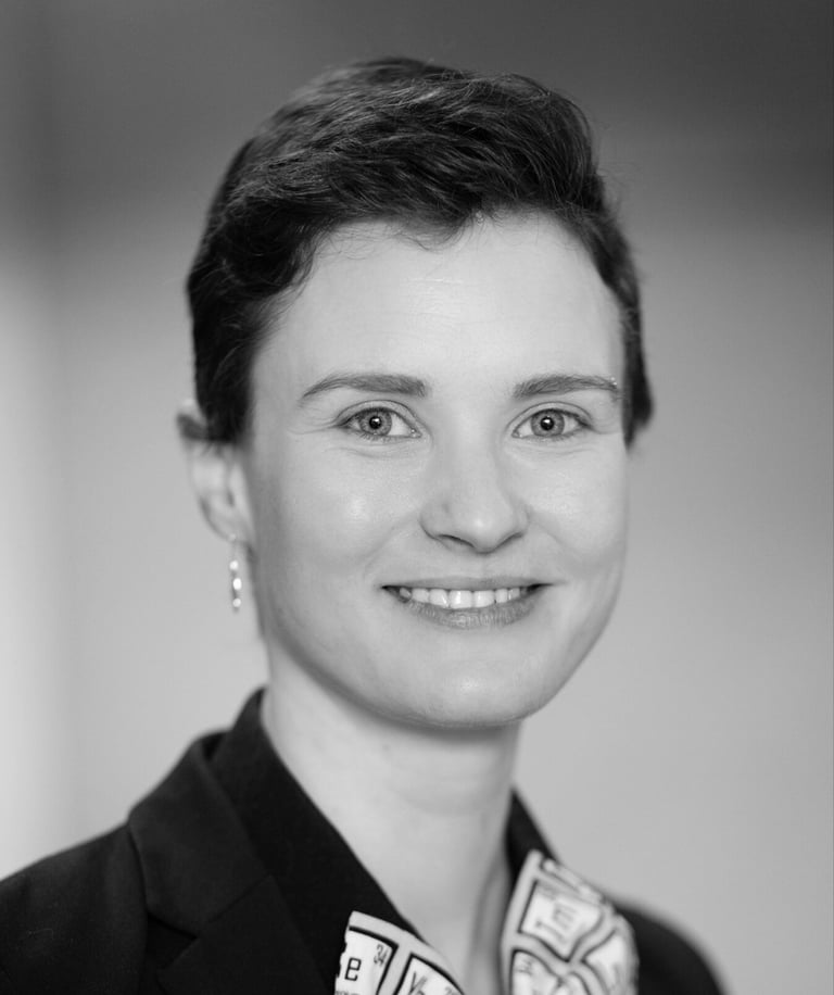 a woman in a suit and tie smiling