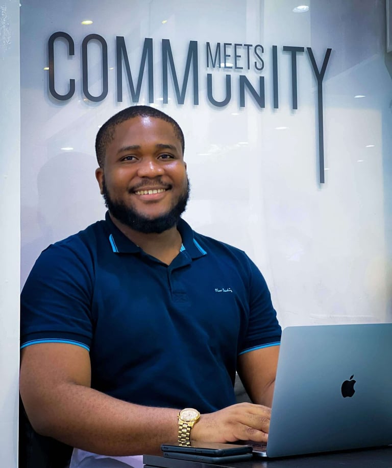 a man sitting at a desk with a laptop computer