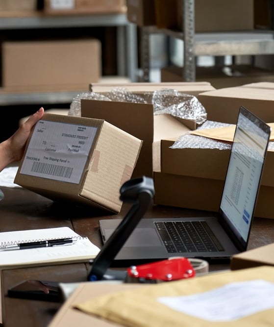 Female eCommerce seller preparing boxes for shipment