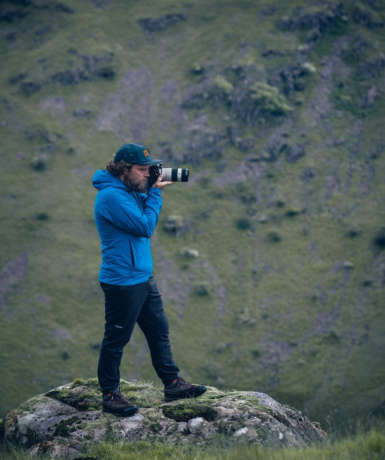 a photo of mike brogden taking photos on a mountain