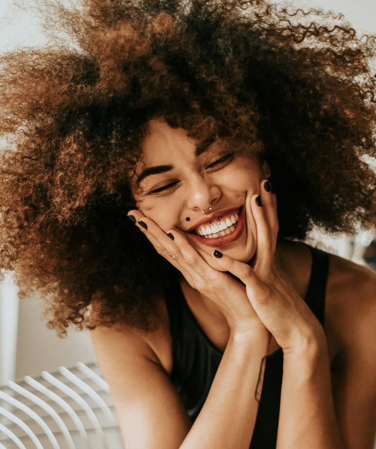 a woman with a curly afro hairs and a black dress