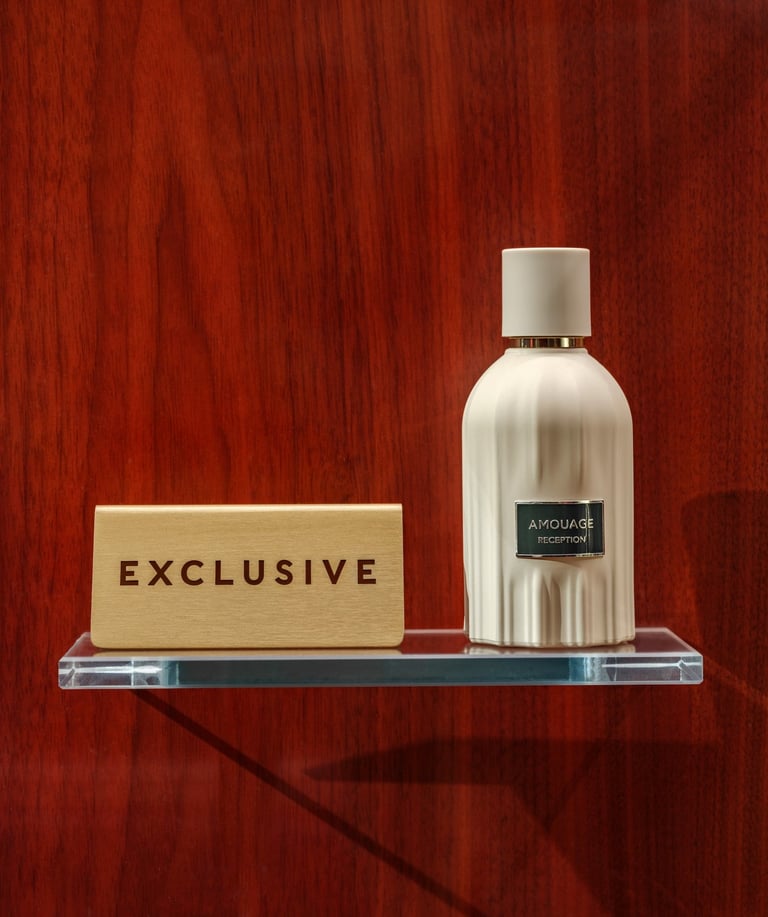 Exclusive Amouage reception perfume bottle on wood backdrop.
