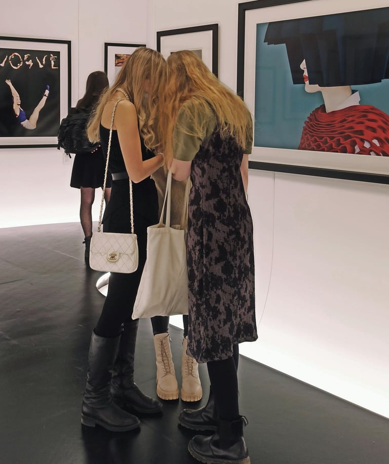 Visitors viewing refugee-led art exhibition in a contemporary gallery