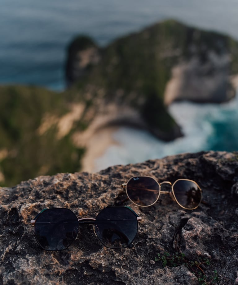 a pair of sunglasses and sunglasses on a rock