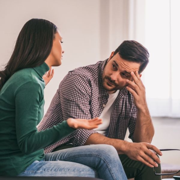 a man and woman sitting on a couch in a living room