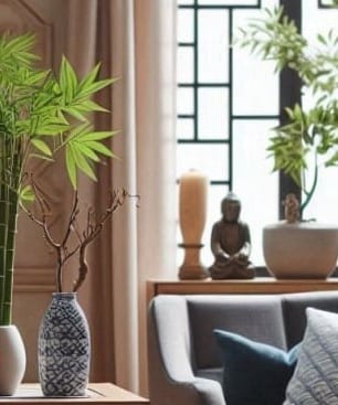 a man sitting at a table with a plant in a vase