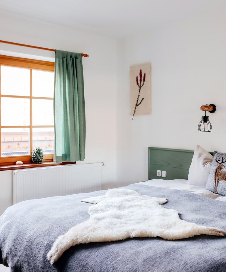 a bed with a white bed and a window