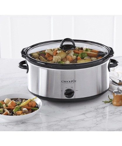 a crock pot slow cooker with stew cooking