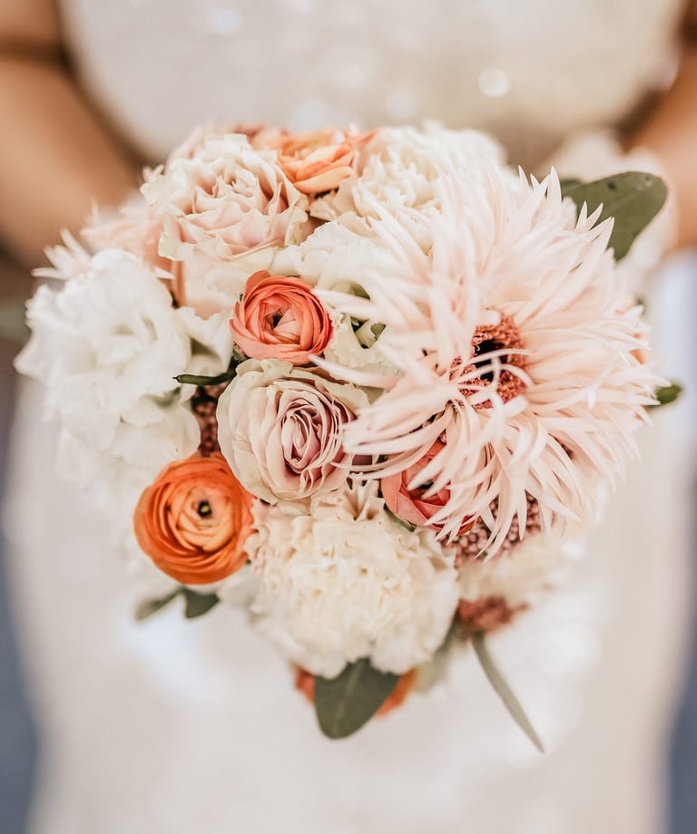 a bridesmael holding a bouquet of flowers
