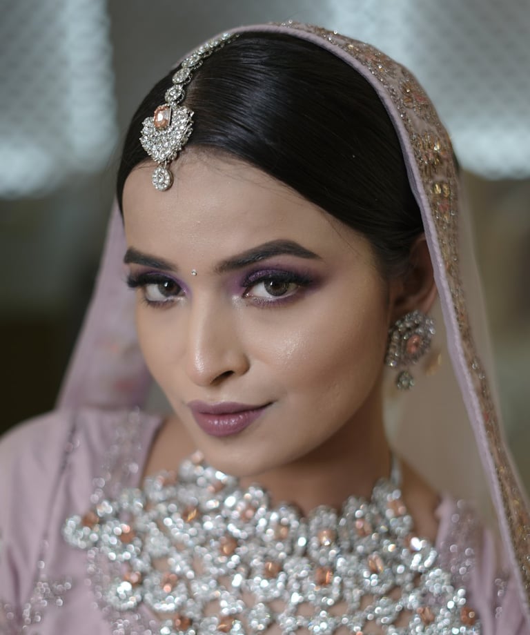 Indian bride-to-be in pastel lavender outfit with soft glam engagement makeup, shimmer eyes, gemston