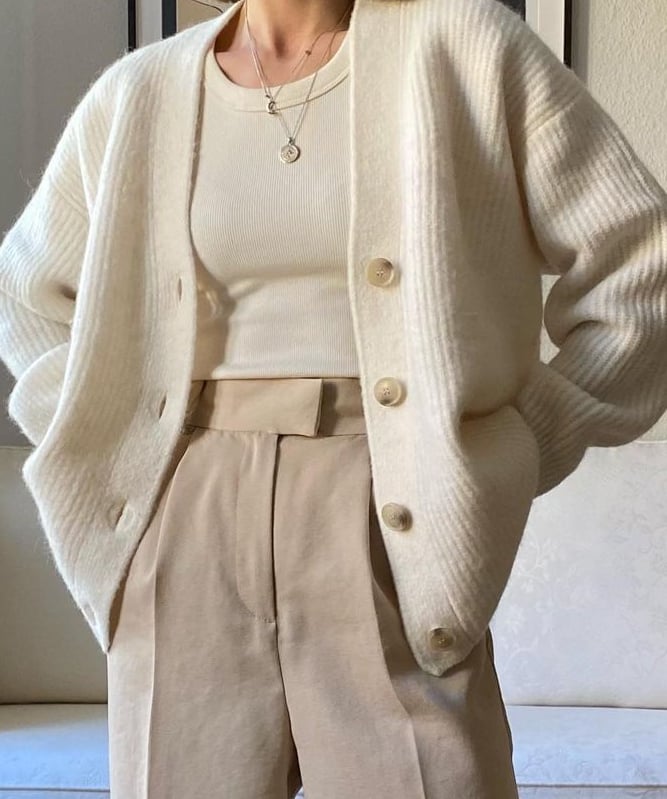 a woman in a white sweater and pants with a white sweater and a white sweater