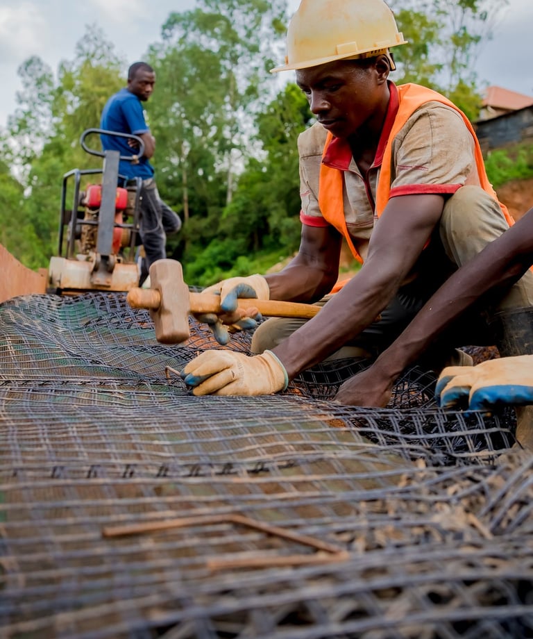 Close-up of geogrid reinforcement being installed for soil stabilization.