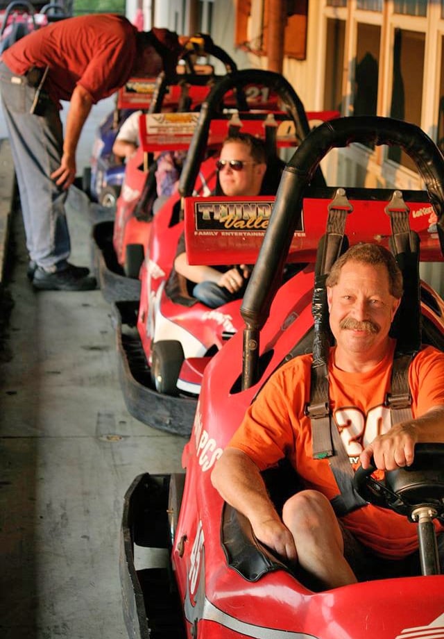 man posing in outdoor go kart line