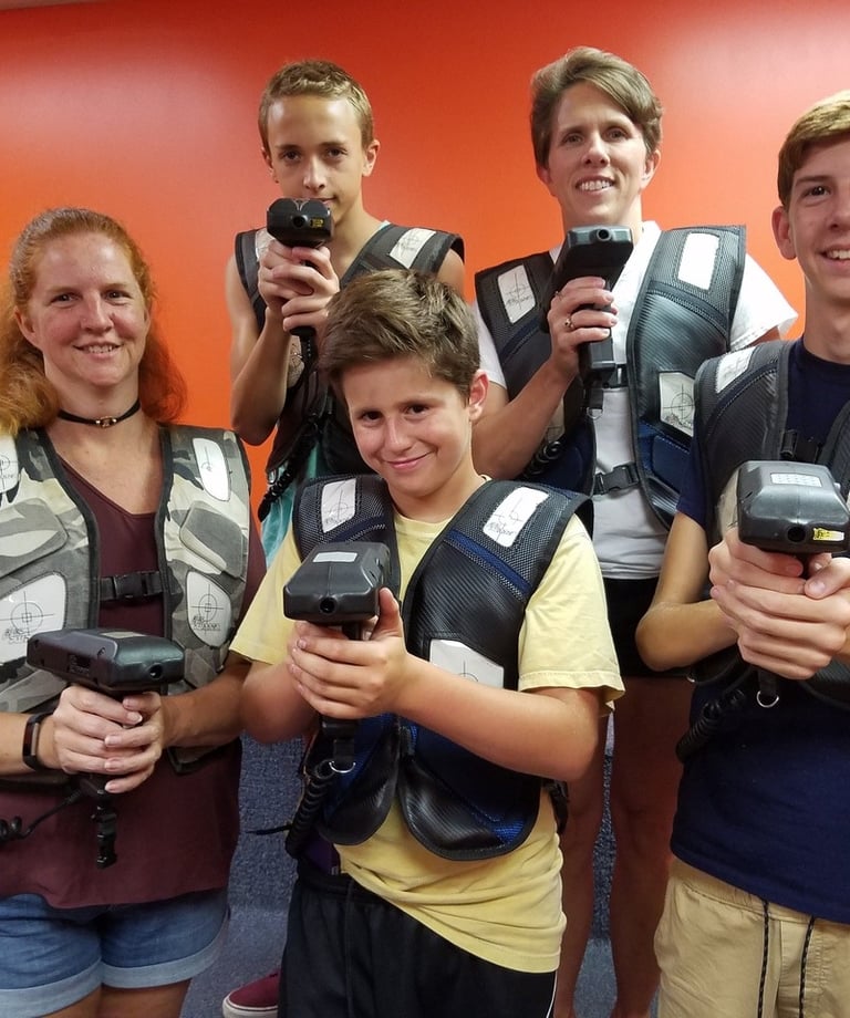 family posing for laser tag