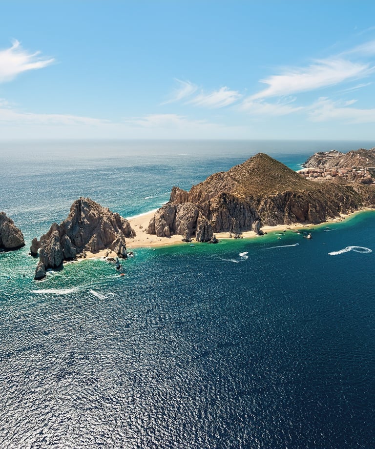 a group of boats sailing in the ocean