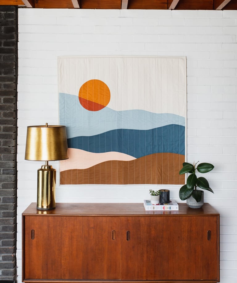 a painting of a sunset over a dresser