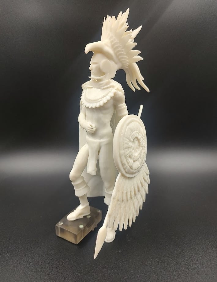 A 3D printed Aztec eagle warrior miniature statue with detailed headdress, shield, and spear.
