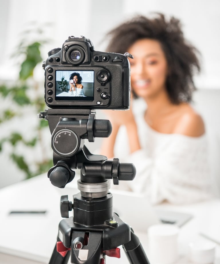 a woman is taking a video camera and recording a video of a woman in a