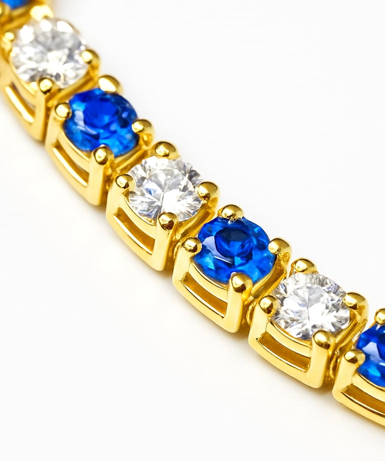 a gold bracelet with blue and white diamonds