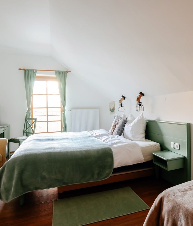a woman in a white dress standing in a bedroom