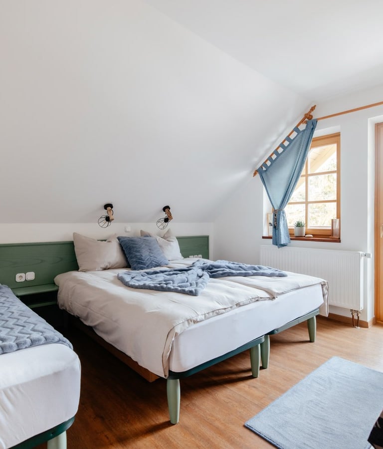 a bedroom with two beds and a chair