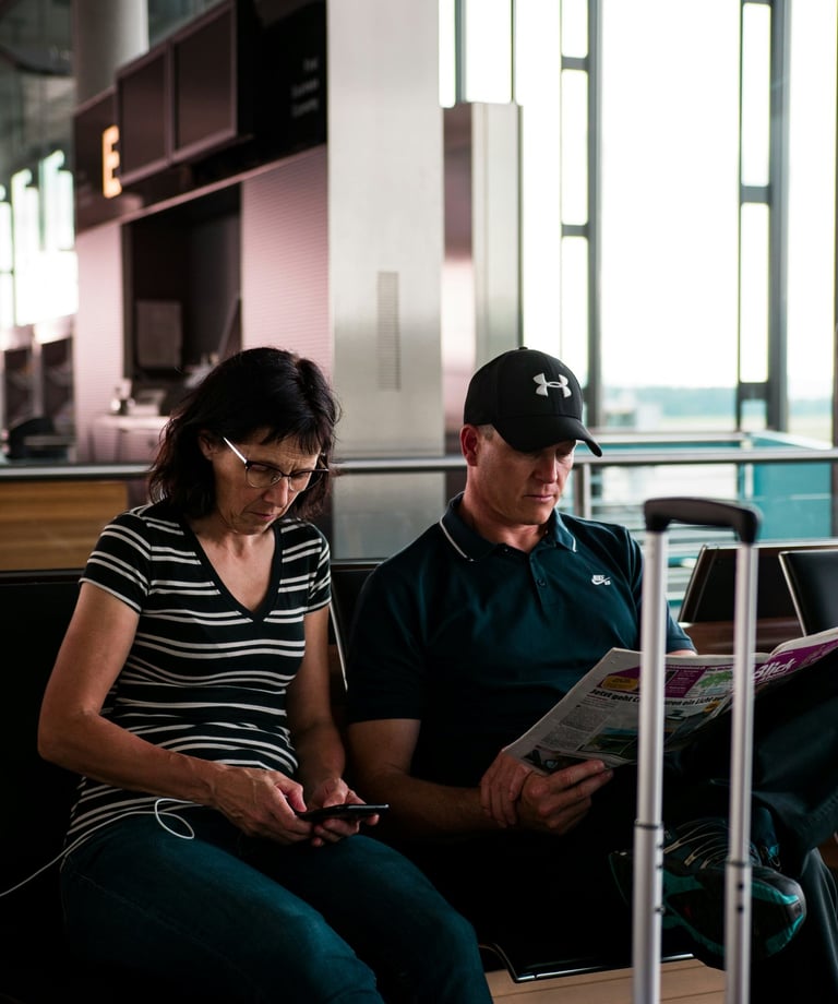 Women looking at phone in airport