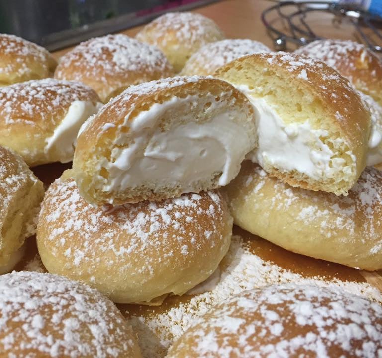 a pile of doughnuts with a bite out of it
