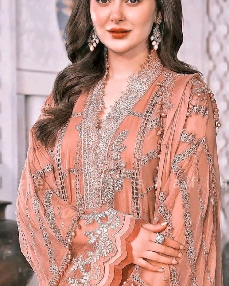 a woman in a designers pink embroidered dress 