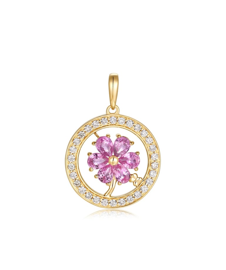 a pink and gold pendant with a flower in the center