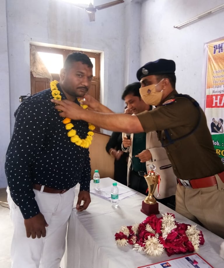 a man in uniform is being awarded by a man in uniform