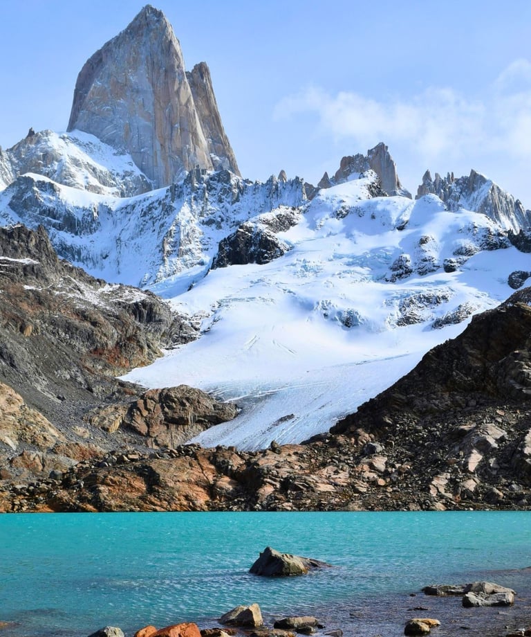 Turquoise glacial lake at the base of snow-capped Mount Fitz Roy peak in Patagonia, Argentina.