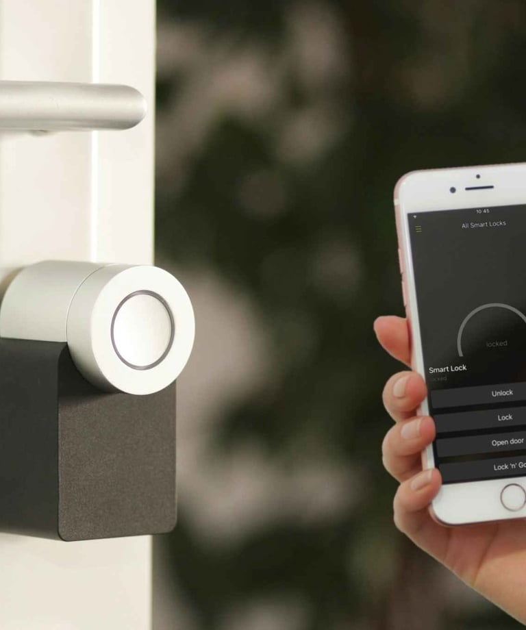 a person holding a smart phone in front of a door