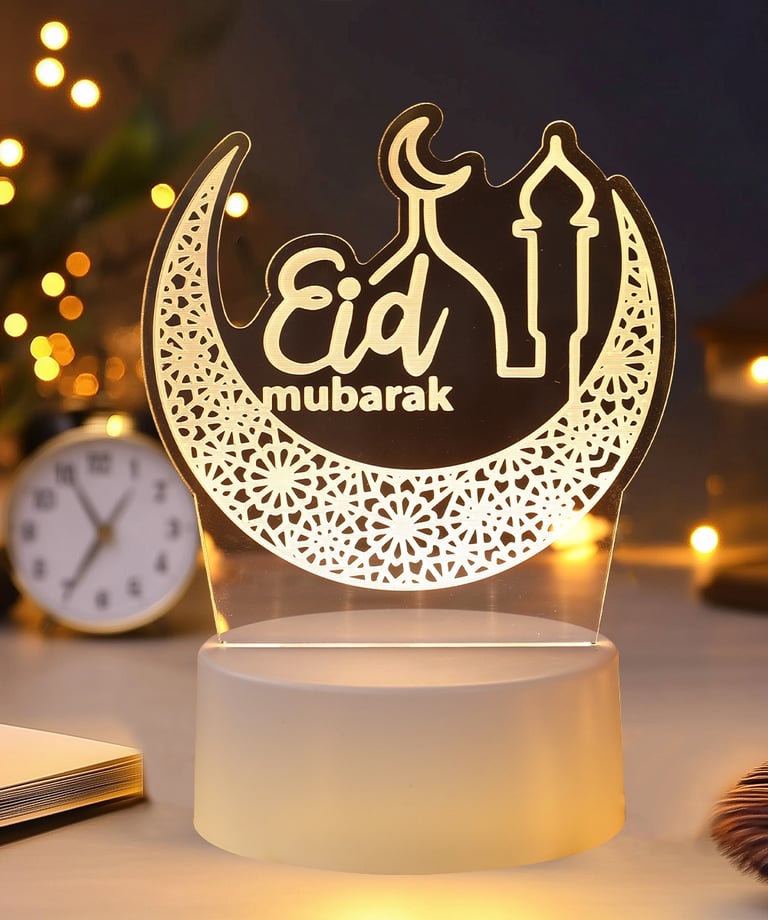 an LED lit desk top ornament with eid mubarak engraved on a crescent moon design  